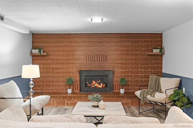 4100 Shaw Blvd, Westminster, CO 80031 - living area with brick wall, wood finished floors, wainscoting, and a brick fireplace