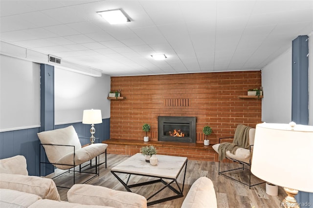 4100 Shaw Blvd, Westminster, CO 80031 - living room with wood finished floors, a brick fireplace, and brick wall