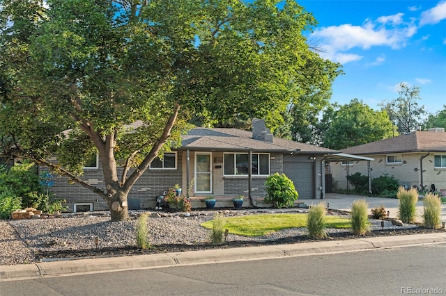 4100 Shaw Blvd, Westminster, CO 80031 - view of front of house with a garage, concrete driveway, brick siding, and a chimney