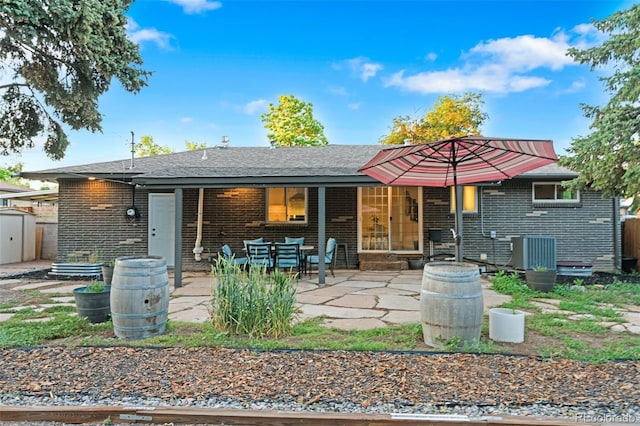 4100 Shaw Blvd, Westminster, CO 80031 - back of property with brick siding, a patio area, and a storage unit