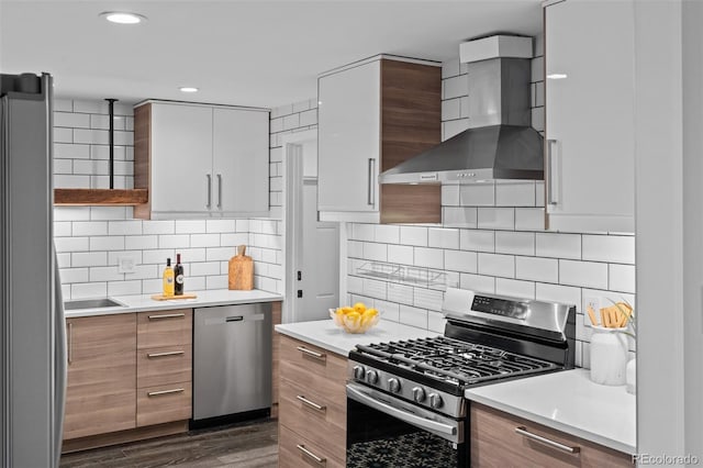 4100 Shaw Blvd, Westminster, CO 80031 - kitchen featuring stainless steel appliances, wall chimney range hood, modern cabinets, and recessed lighting