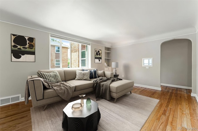 1535 Hudson St Unit 1, Denver, CO 80220 - living area with arched walkways, wood finished floors, and baseboards