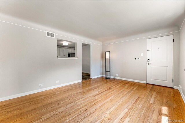 1535 Hudson St Unit 1, Denver, CO 80220 - unfurnished living room featuring light wood finished floors and baseboards
