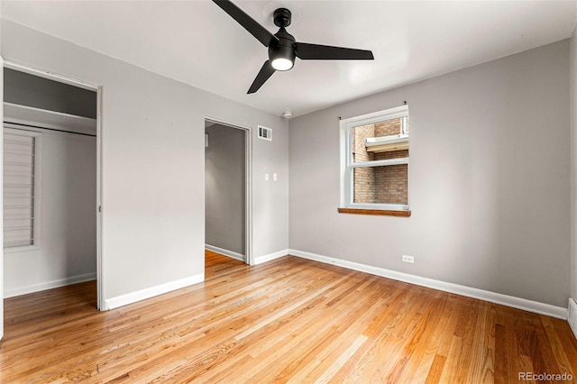 1535 Hudson St Unit 1, Denver, CO 80220 - unfurnished bedroom with baseboards, wood finished floors, and a ceiling fan