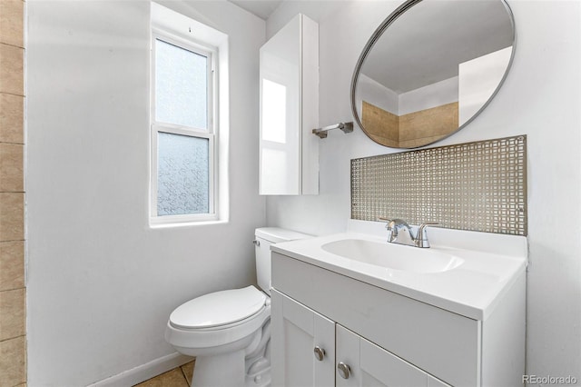 1535 Hudson St Unit 1, Denver, CO 80220 - half bathroom with vanity, toilet, baseboards, and tile patterned flooring