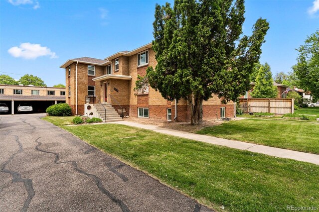 1535 Hudson St Unit 1, Denver, CO 80220 - view of front of house with brick siding and a front lawn