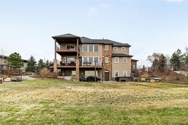 rear view of property featuring a deck and a lawn