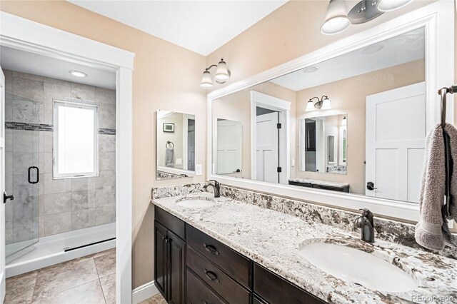 bathroom with vanity, tile patterned flooring, and walk in shower