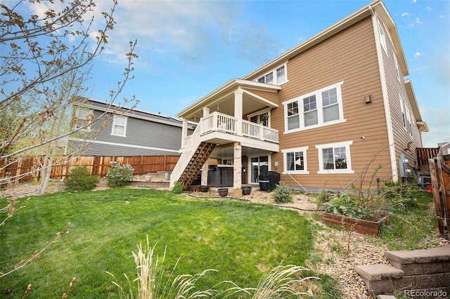 6173 Eldora St, Golden, CO 80403 - back of property with stairs, a vegetable garden, and a deck