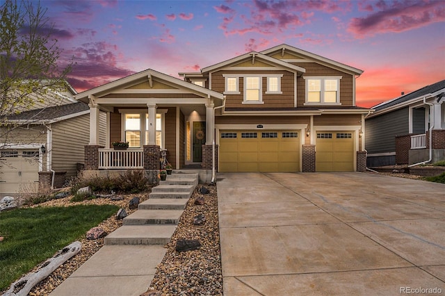 6173 Eldora St, Golden, CO 80403 - craftsman inspired home with a porch, a garage, concrete driveway, and brick siding