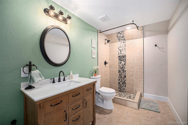 6173 Eldora St, Golden, CO 80403 - full bath with toilet, tiled shower, vanity, tile patterned floors, and a textured wall