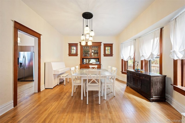 1430 Monroe St, Denver, CO 80206 - dining room featuring a chandelier, light wood finished floors, plenty of natural light, and baseboards