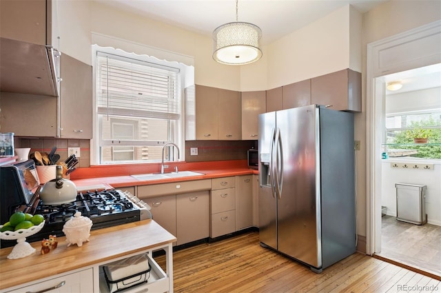 1430 Monroe St, Denver, CO 80206 - kitchen with stainless steel fridge with ice dispenser, a sink, light wood finished floors, and tasteful backsplash