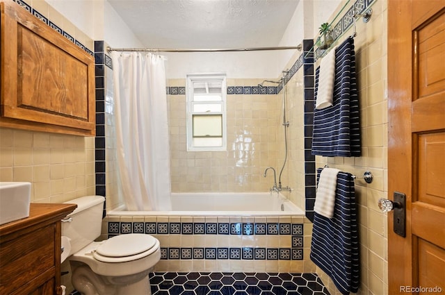 1430 Monroe St, Denver, CO 80206 - bathroom featuring tiled shower / bath, toilet, vanity, tile walls, and a textured ceiling
