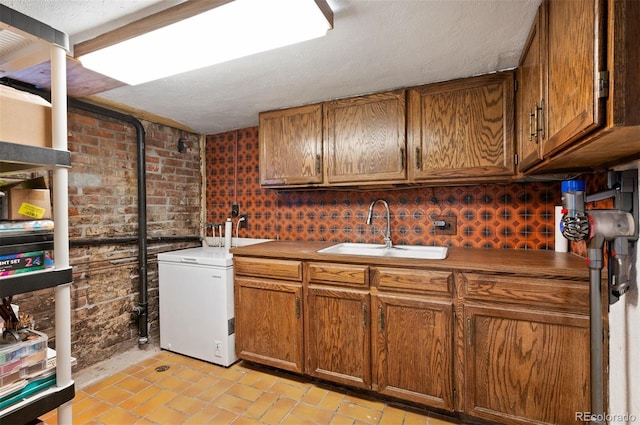 1430 Monroe St, Denver, CO 80206 - kitchen featuring a sink, brown cabinetry, and white refrigerator