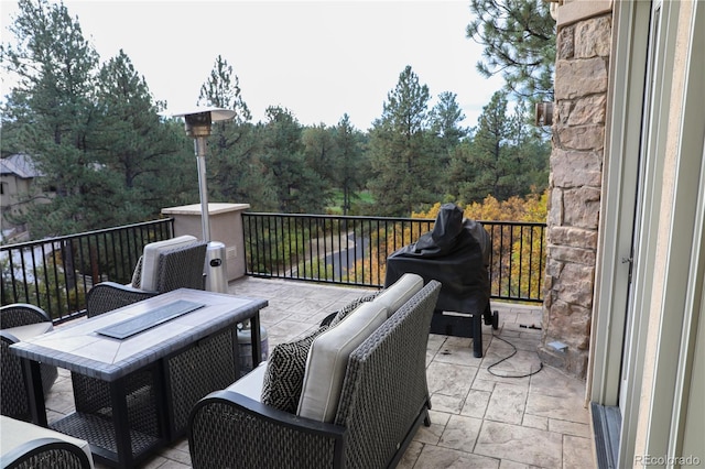 view of patio / terrace with grilling area and a balcony