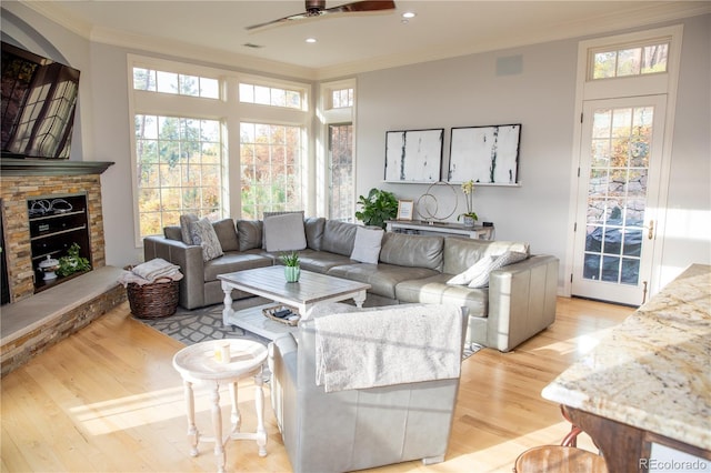 living area featuring a ceiling fan, light wood-style floors, ornamental molding, visible vents, and recessed lighting