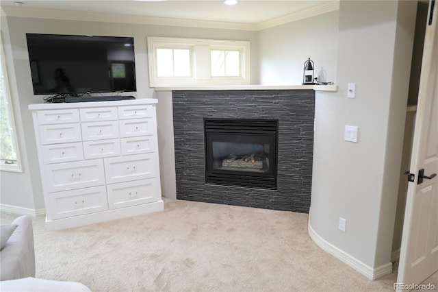 carpeted living room featuring ornamental molding, plenty of natural light, and a fireplace