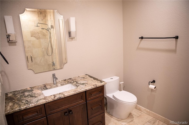 bathroom featuring vanity, walk in shower, and toilet