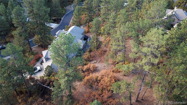 birds eye view of property featuring a wooded view