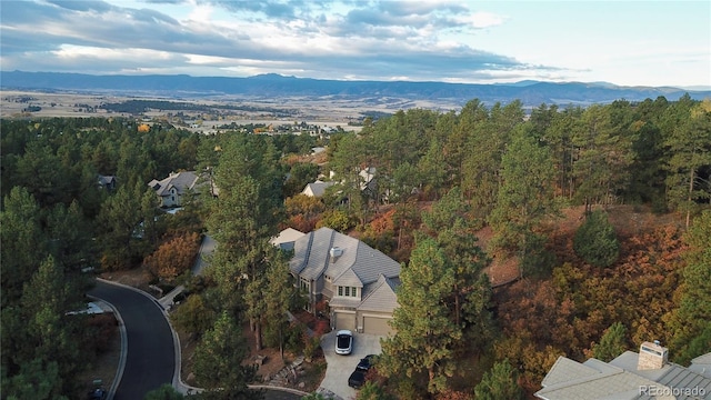 aerial view featuring a mountain view and a wooded view