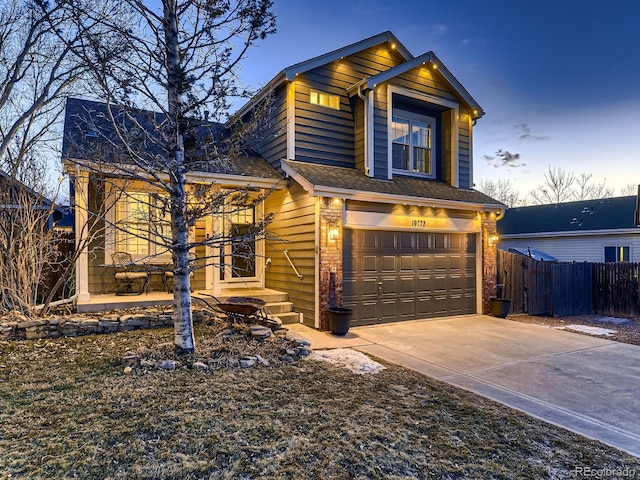 view of front of property featuring an attached garage, a shingled roof, fence, and concrete driveway