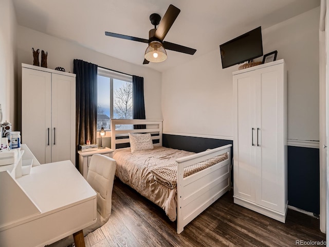 bedroom featuring ceiling fan and dark wood-style flooring