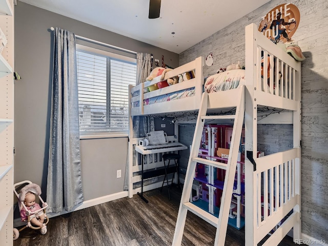 bedroom with a ceiling fan, baseboards, and wood finished floors