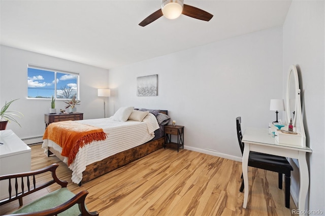9240 W 49th Ave Unit 317, Wheat Ridge, CO 80033 - bedroom featuring a baseboard heating unit, light wood-style flooring, and ceiling fan
