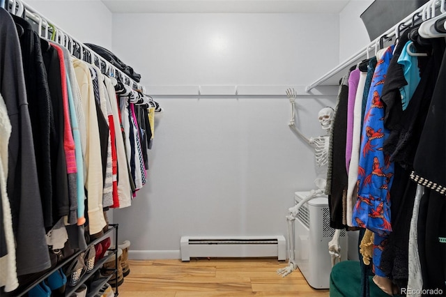 9240 W 49th Ave Unit 317, Wheat Ridge, CO 80033 - walk in closet featuring a baseboard heating unit and wood finished floors