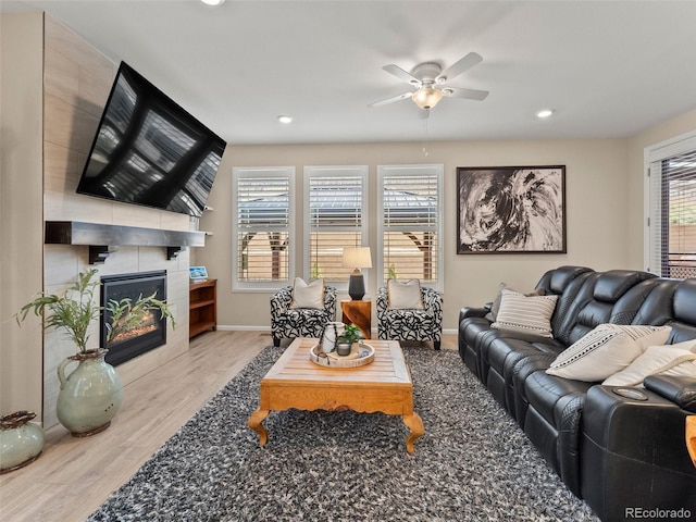 4538 Hidden Gulch Rd, Castle Rock, CO 80104 - living area featuring a tile fireplace, wood finished floors, a ceiling fan, baseboards, and recessed lighting