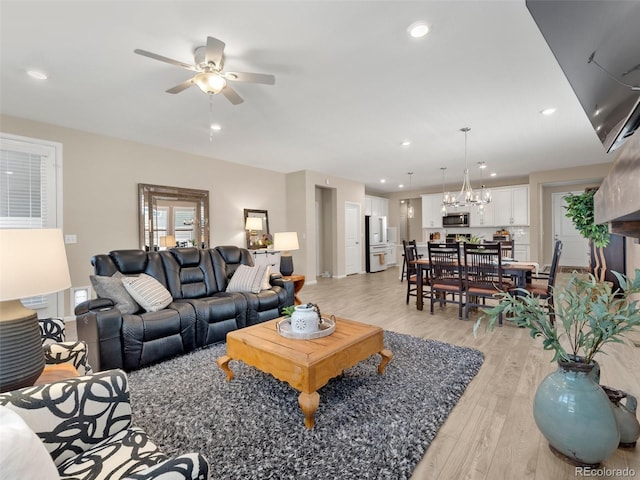 4538 Hidden Gulch Rd, Castle Rock, CO 80104 - living room featuring light wood-style flooring, ceiling fan with notable chandelier, baseboards, and recessed lighting