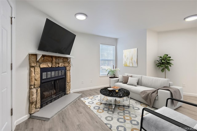 living room featuring hardwood / wood-style flooring and a fireplace