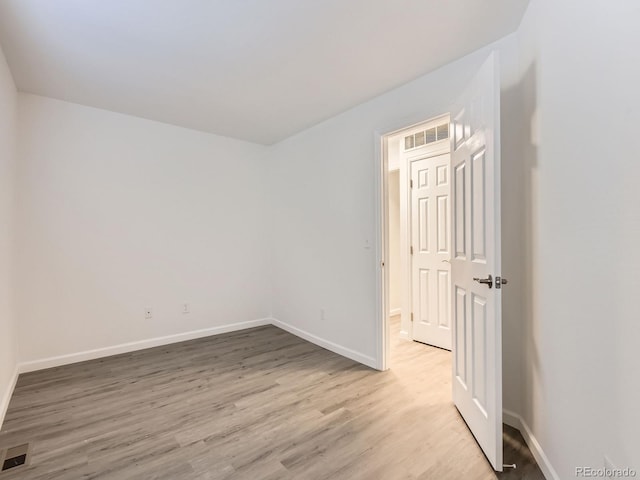 spare room with light wood-type flooring