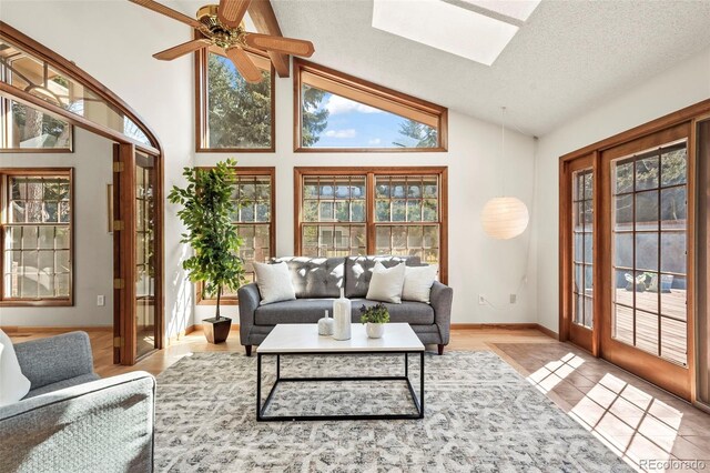 sunroom / solarium with vaulted ceiling with skylight and ceiling fan