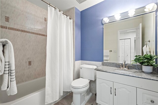 bathroom featuring vanity, toilet, and shower / bathtub combination with curtain