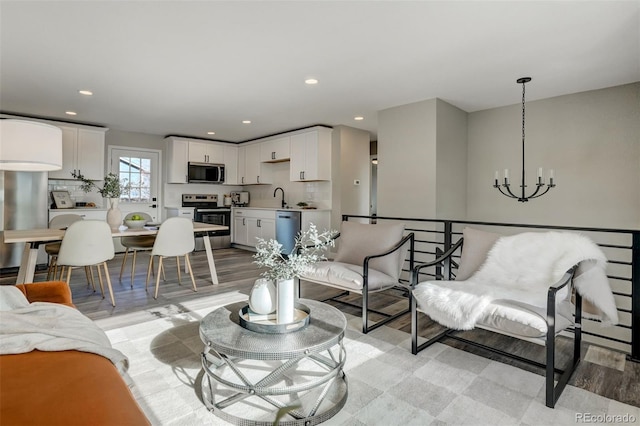 living room featuring a notable chandelier and sink