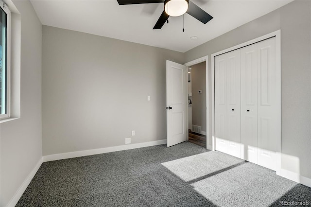 unfurnished bedroom with ceiling fan, a closet, and carpet floors