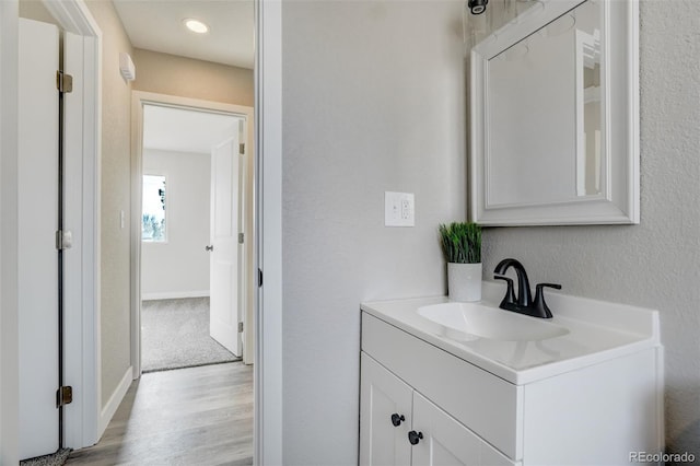 bathroom with vanity and hardwood / wood-style flooring