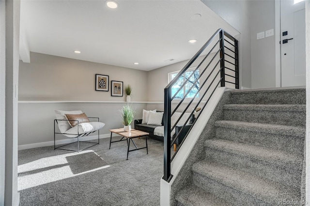 stairway featuring carpet floors