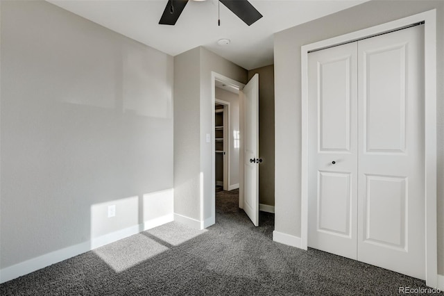 unfurnished bedroom with ceiling fan, a closet, and dark carpet