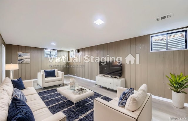8610 Jolene Dr, Denver, CO 80229 - living area featuring wood finished floors and wooden walls