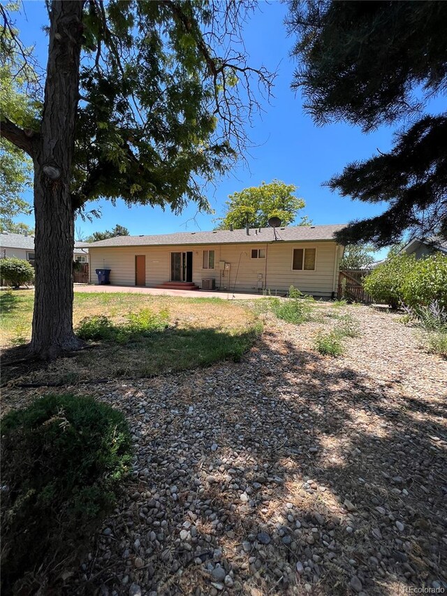 rear view of house with a lawn and a patio area