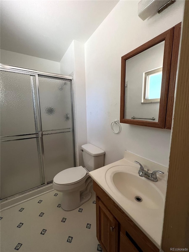 bathroom with vanity, toilet, and walk in shower