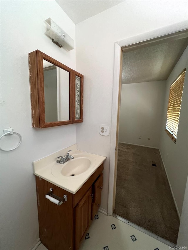 bathroom with vanity and a textured ceiling