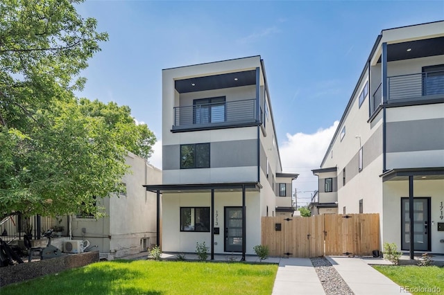 1713 Grove St, Denver, CO 80204 - view of front of house featuring stucco siding, a cooling unit, and a gate