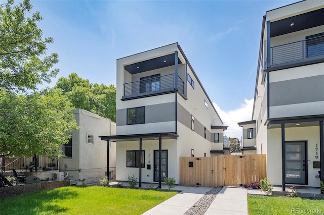 1713 Grove St, Denver, CO 80204 - back of house featuring stucco siding, a gate, and a balcony