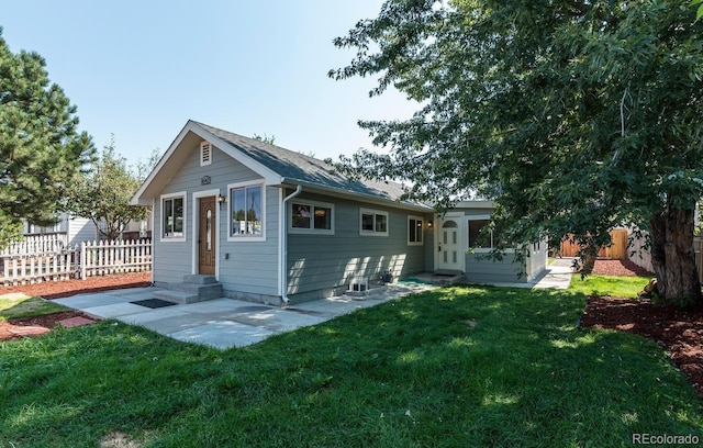 back of house with a lawn