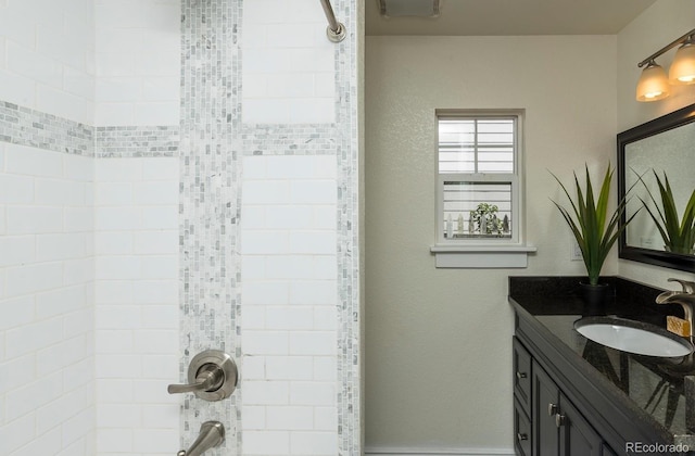 bathroom with vanity and tiled shower / bath combo