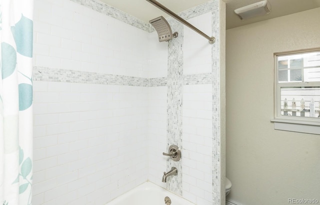 bathroom featuring shower / bath combo with shower curtain and toilet